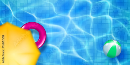 Swimming pool top view with mosaic tiles, inflatable ring, ball and sun awning. Water surface in light blue colors with sunlight glares and caustic ripples. Summer holiday background.
