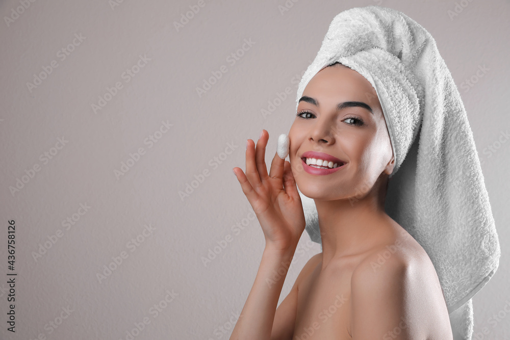 Woman using silkworm cocoon in skin care routine on light grey background. Space for text Woman using silkworm cocoon in skin care routine on light grey background. Space for text