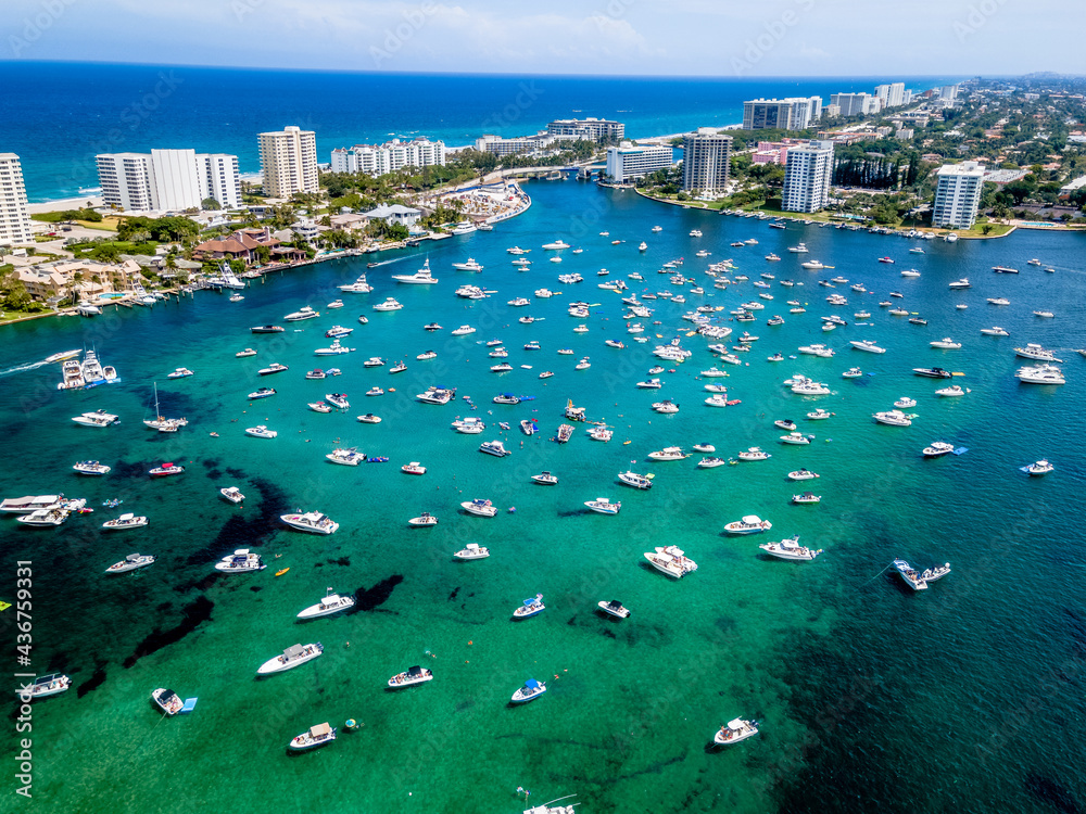 aerial drone of City in Lake Boca Raton, Florida with boats
