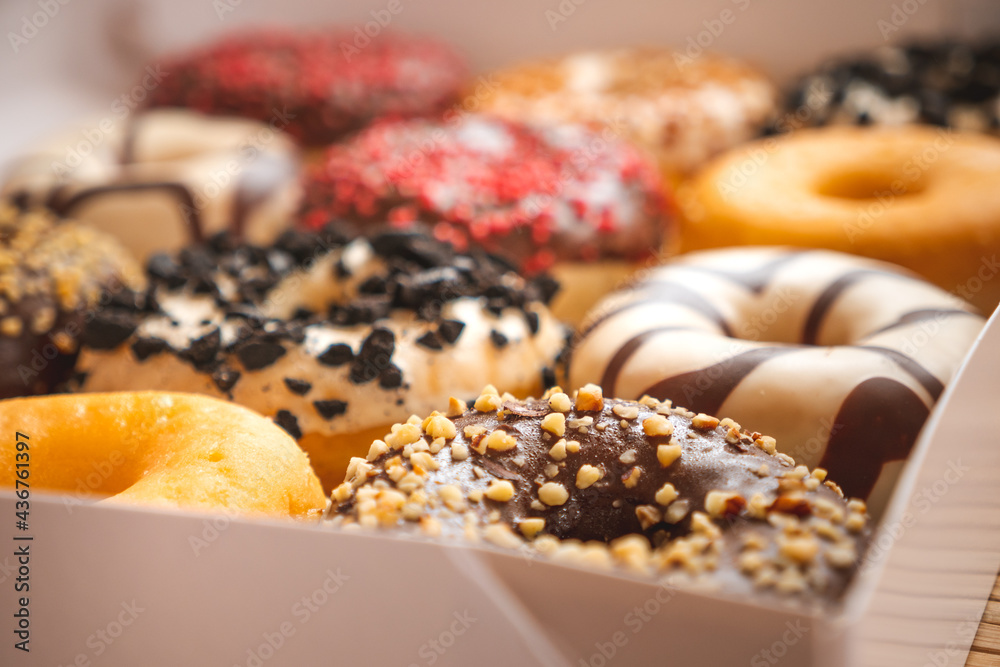 Assortment of donuts of different flavors in a box.
Assortment of donuts of different flavors in a box.