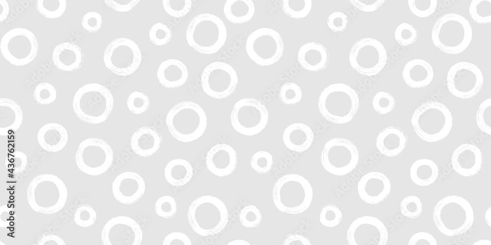 Black and white seamless pattern with rings in brush stroke technique. Abstract background with hand painted circles.