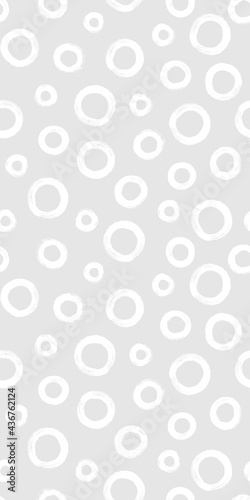 Black and white seamless pattern with rings in brush stroke technique. Abstract background with hand painted circles.