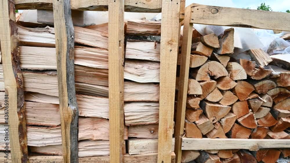 Chopped and stacked firewood. Logs of firewood stacked in boxes. Stock for winter.