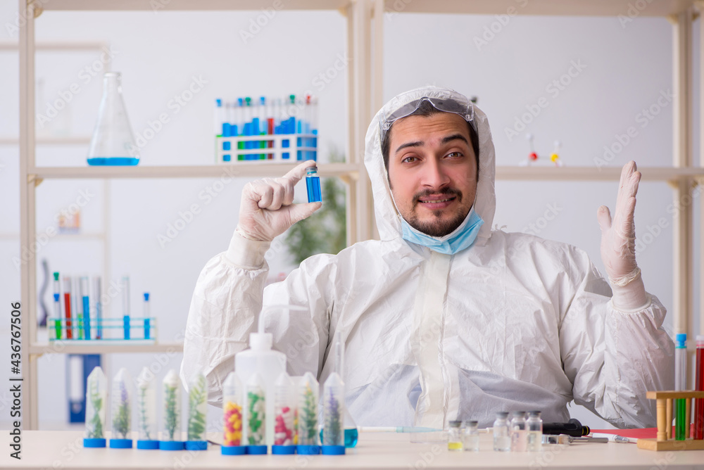 Young male chemist working at the lab during pandemic Young male chemist working at the lab during pandemic