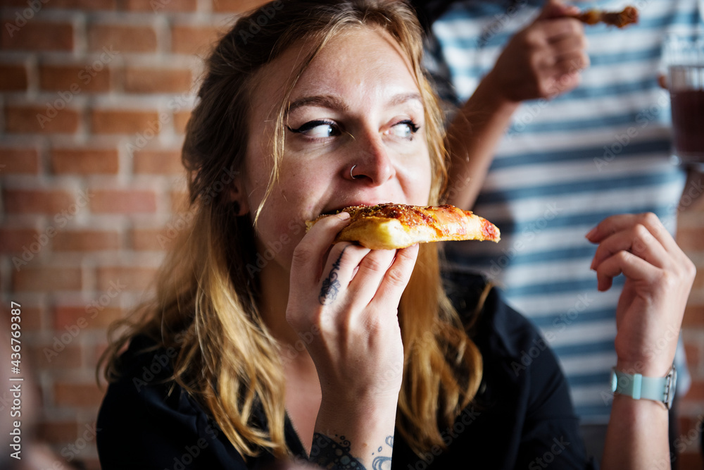 Friends eating pizza together at home Friends eating pizza together at home