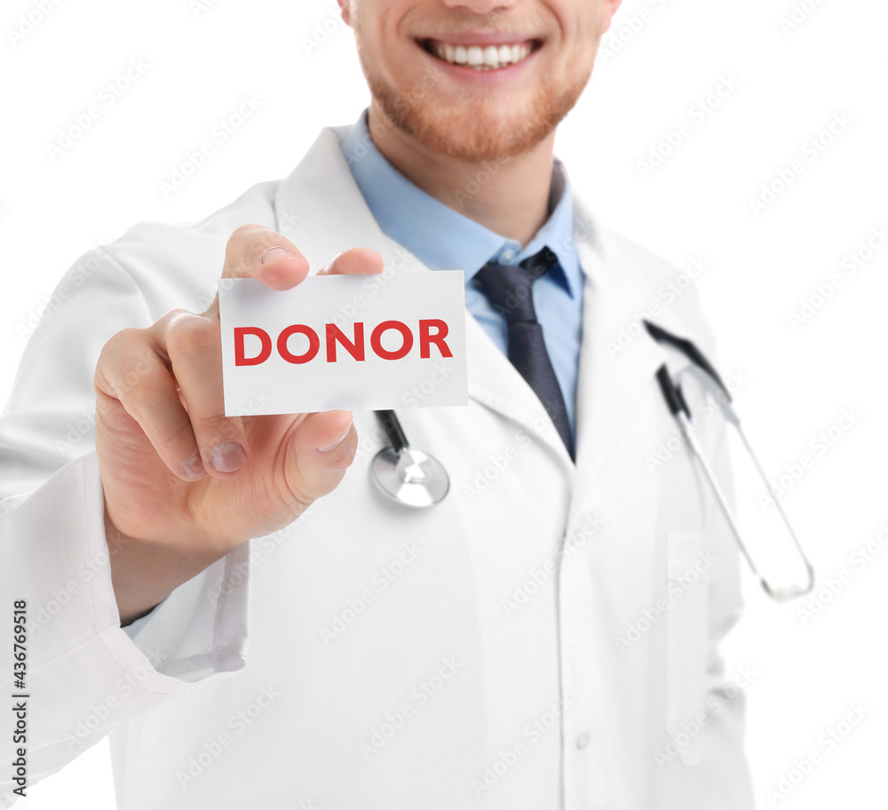 Doctor holding card with word DONOR on white background, closeup Doctor holding card with word DONOR on white background, closeup
