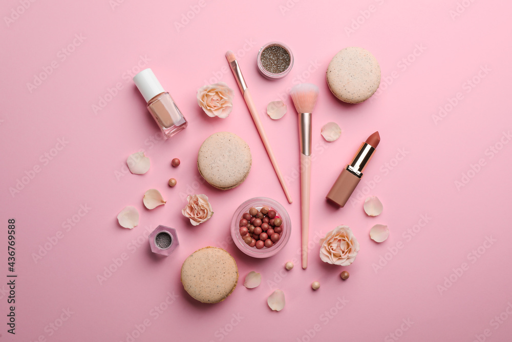 Obraz premium Flat lay composition with makeup products, roses and macarons on pink background