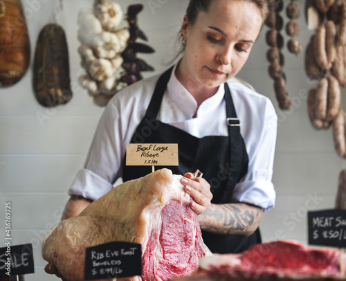 Butcher selling meat in a butcher shop food photography recipe idea photo