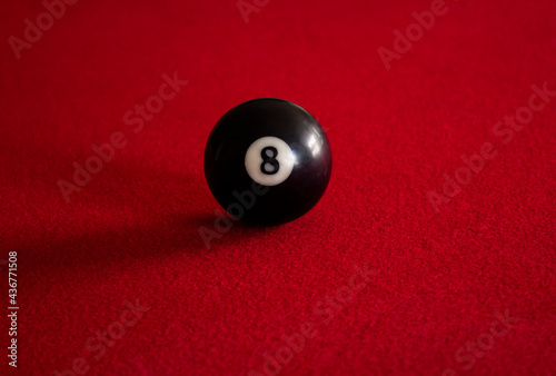 Black eight ball on red table