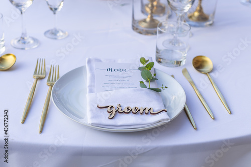 Groom Place Card Dried Romantic Wedding Table Top Layout Table Spread no people no human tropical location with gold cutlery and scenic view leaves and leaf, bride and groom