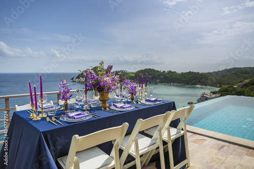 Romantic Wedding Table Top Layout Table Spread no people tropical location with gold cutlery and scenic sea view with copy space