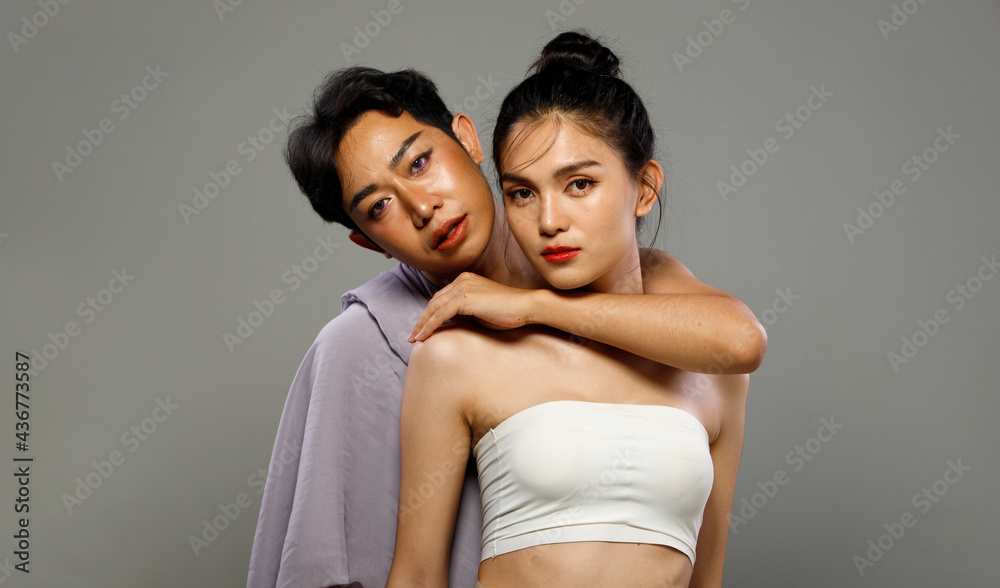 Portrait of 20s Asian LGBTQIA+ Woman and Man hold hug together Portrait of 20s Asian LGBTQIA+ Woman and Man hold hug together