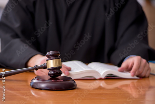 Young male judge working in the courtroom