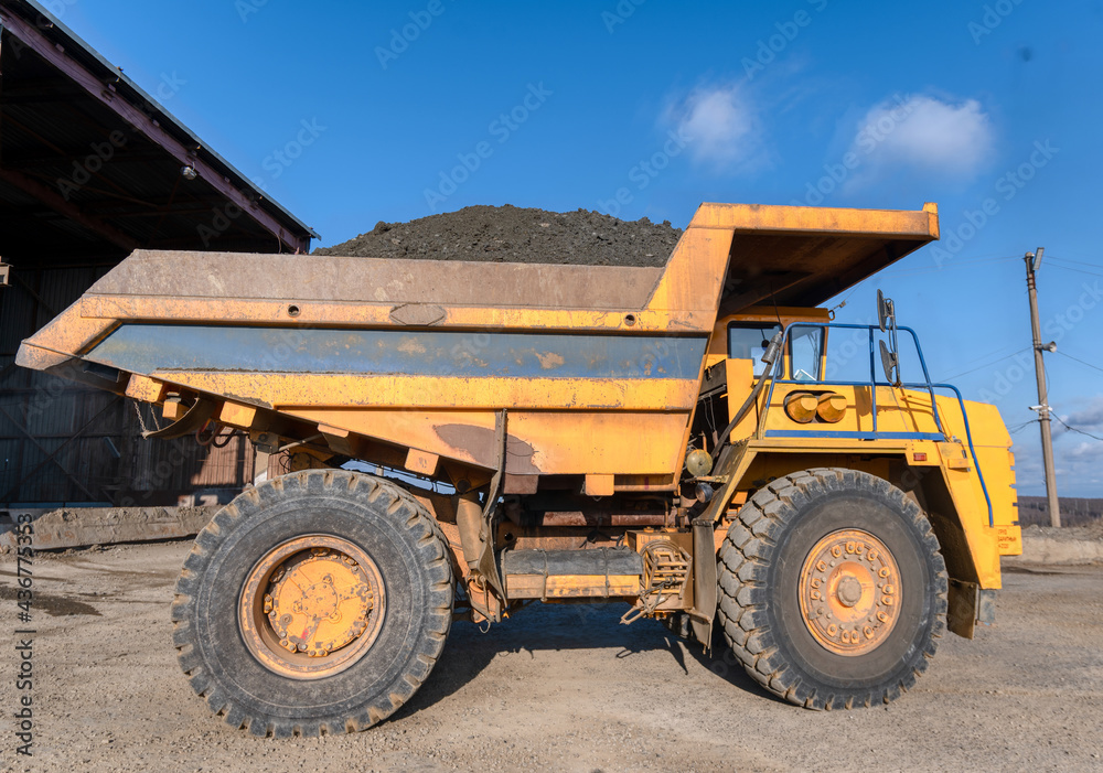 Mining truck dump truck loaded with ore. Transportation of mined ore from the open pit to the surface Mining truck dump truck loaded with ore. Transportation of mined ore from the open pit to the surface