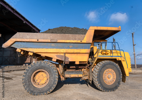 Mining truck dump truck loaded with ore. Transportation of mined ore from the open pit to the surface