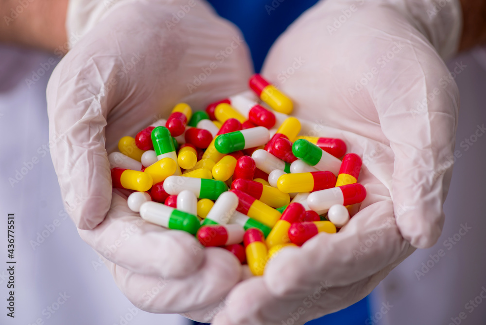 Young male doctor and too many pills Young male doctor and too many pills