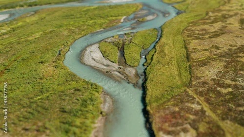 Aerial view of the Langedalen valley, Norway. A shallow river starting at the Austerdalsbreen glacier and cutting through the lush green landscape, feeding marshes and meadows. photo