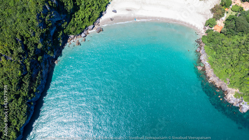 Aerial view azure beach with rocky mountains and blue sea clear water, Sea aerial view, Top view nature background, Sand beach, palm tree and ocean, Thailand.