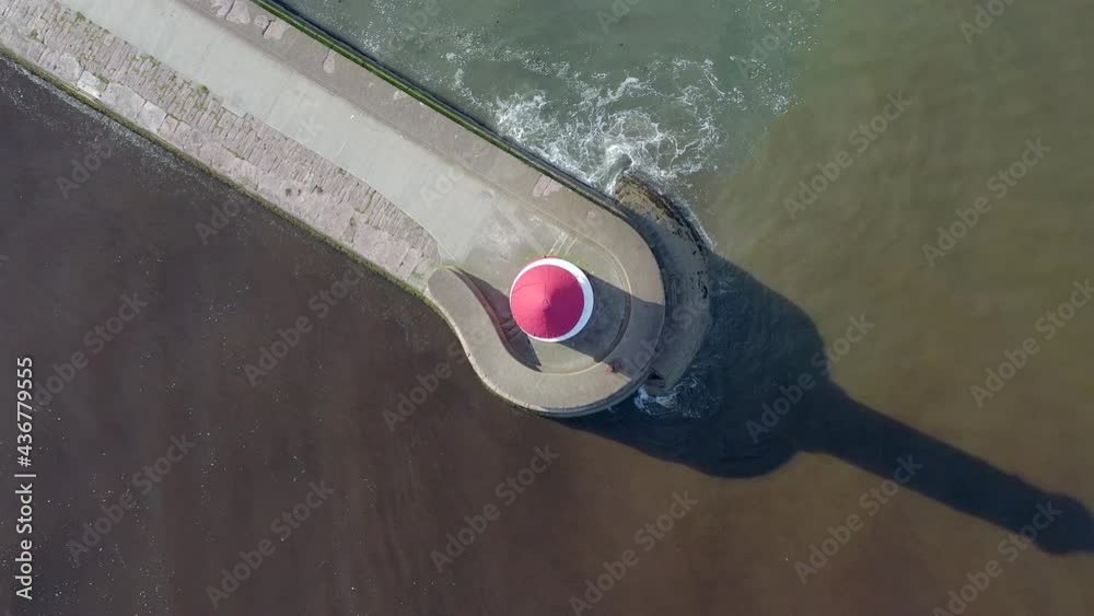 A Lighthouse and Breakwater at the Mouth of a Harbour in the UK A Lighthouse and Breakwater at the Mouth of a Harbour in the UK