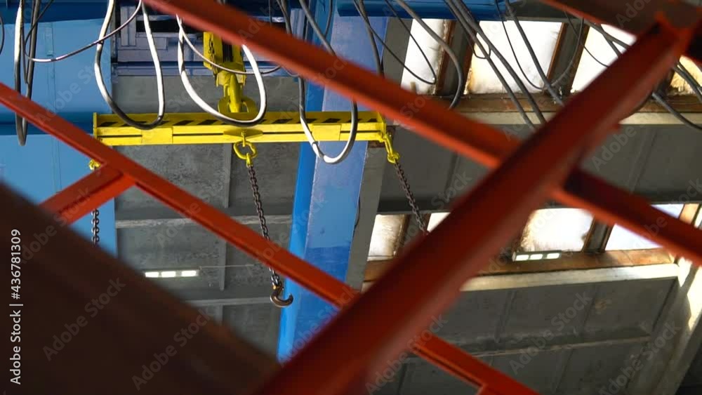 Lifting beam, overhead crane, hoist, gantry with hooks in an industrial factory workshop. Taclke equipment. Lifting beam, overhead crane, hoist, gantry with hooks in an industrial factory workshop. Taclke equipment.