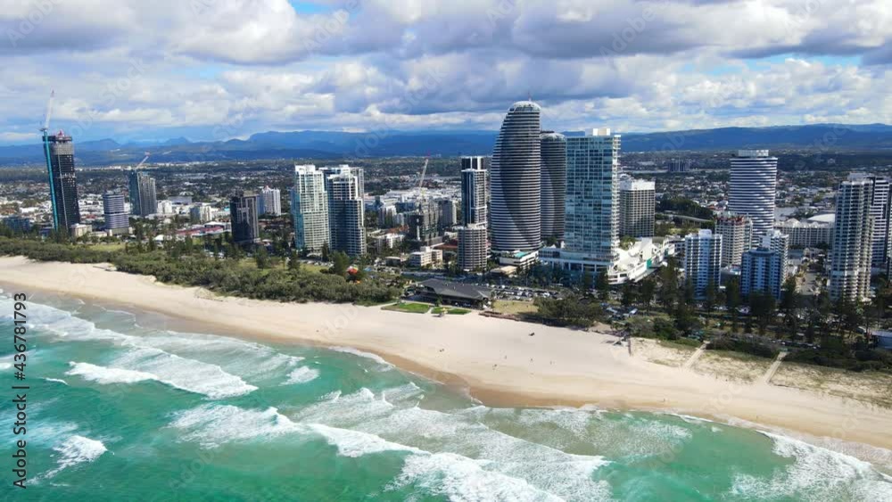Aerial View Of Broadbeach Skyline With Luxury Apartment Hotels - Ocean Waves At Sandy Beach - Gold Coast, QLD, Australia. Aerial View Of Broadbeach Skyline With Luxury Apartment Hotels - Ocean Waves At Sandy Beach - Gold Coast, QLD, Australia.