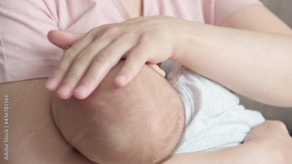 4k Newborn Baby Hand Holding Mother, Mom breastfeeding touching baby tiny hand to make him feeling her love, warm and secure. Infant child drinking milk. Maternity, family, birth concept. 4k Newborn Baby Hand Holding Mother, Mom breastfeeding touching baby tiny hand to make him feeling her love, warm and secure. Infant child drinking milk. Maternity, family, birth concept.