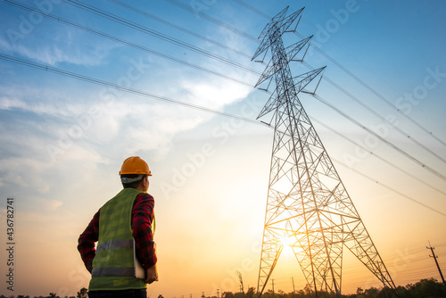 electrical engineer working at the power station See the planning of electricity production at high voltage poles. photo