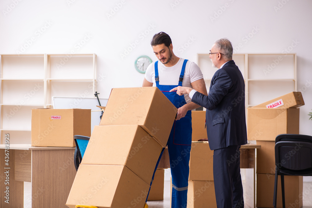 Old businessman and young contractor in relocation concept