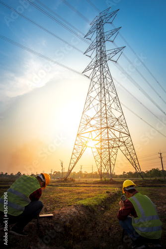 Picture of two electrical engineers checking electrical work by taking a picture at the power station to see the planning work at the high voltage electrode. photo