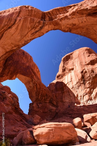 double arch red rock formation on a sunny day in arches national park, near moab, utah