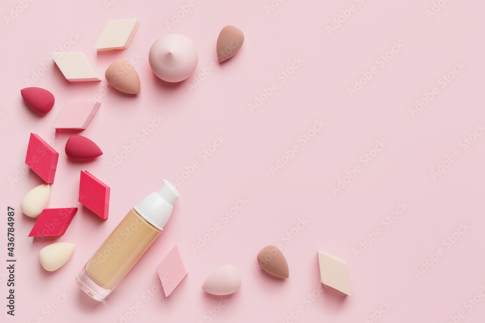 Makeup sponges with bottle of tonal foundation on color background Makeup sponges with bottle of tonal foundation on color background