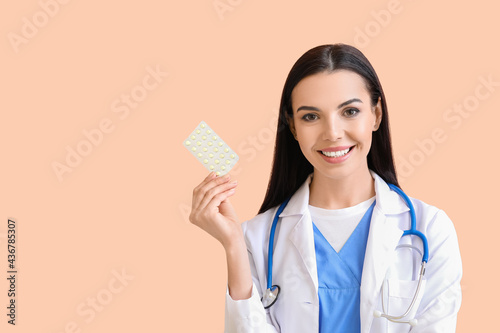 Female doctor with pills on...