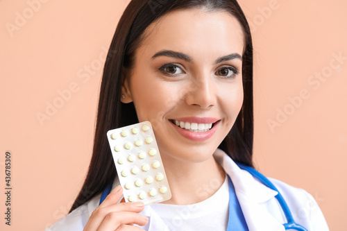 Female doctor with pills on...