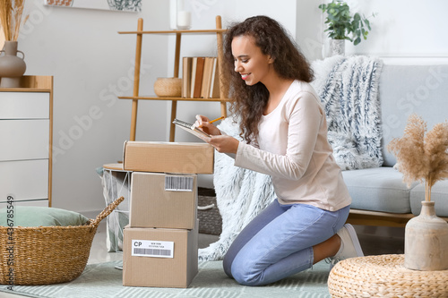 Young woman with parcel wri...