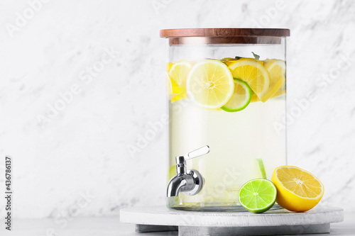 Obraz na płótnie Jug of tasty cold lemonade on light background