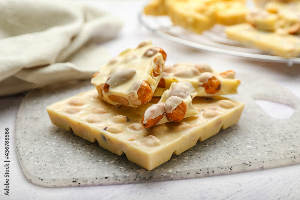 Delicious white chocolate with nuts on  table