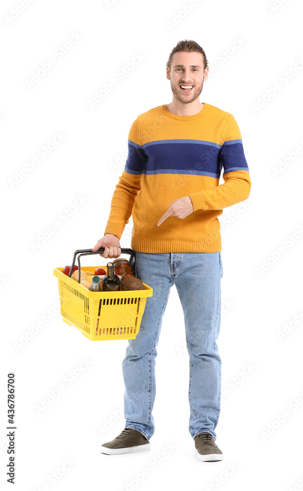 Young man with shopping basket on white background Young man with shopping basket on white background