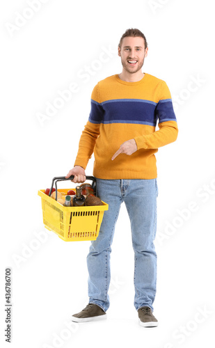 Happy young man holding yel...