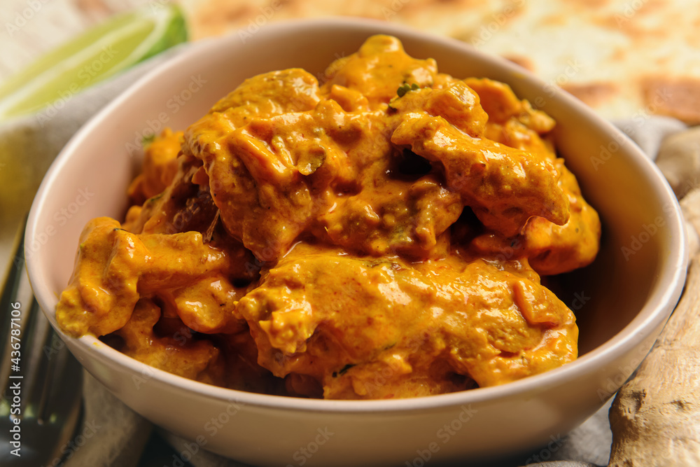 Bowl of tasty chicken tikka masala on table, closeup Bowl of tasty chicken tikka masala on table, closeup