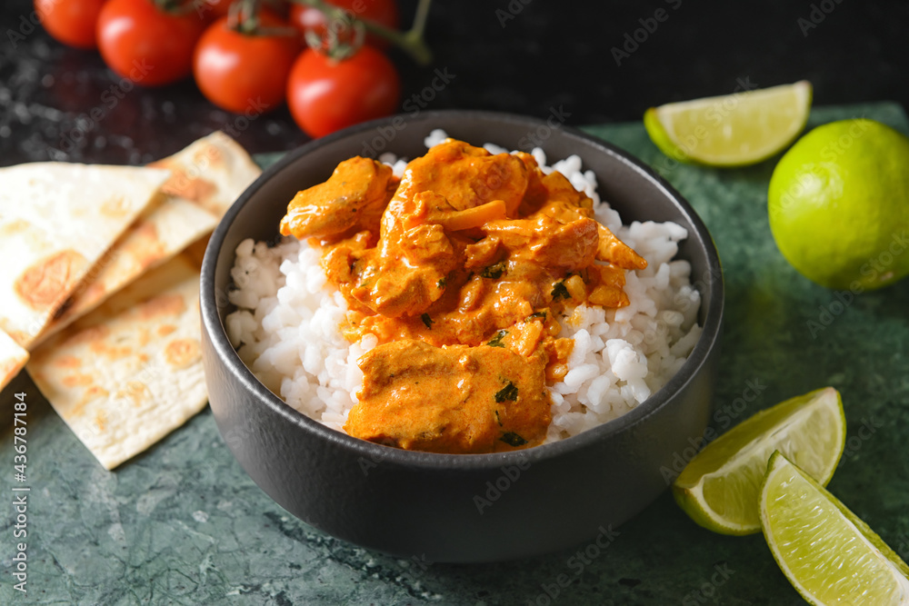 Bowl of tasty chicken tikka masala and rice on table Bowl of tasty chicken tikka masala and rice on table