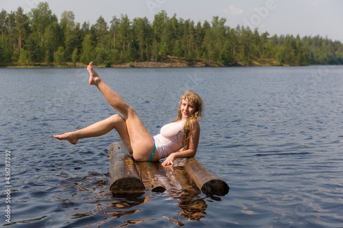 girl sitting on a raft in summer photo