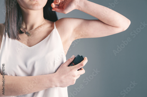 young girl with aerosol deodorant