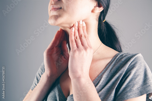 a young woman has a sore throat