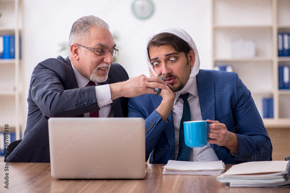 Young male employee suffering from toothache in the office