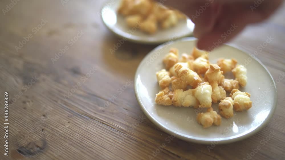 Hands of a person who sprinkles salt on a rice cake Hands of a person who sprinkles salt on a rice cake