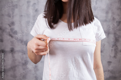 young girl measures breast girth