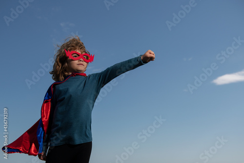 Excited child boy dressed like superhero. Super hero concept.