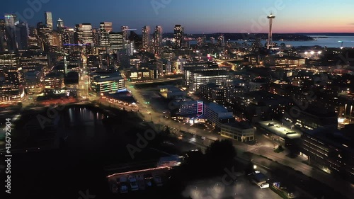Cinematic 4K drone, after sunset, night dolly shot of downtown Seattle with illuminated streets and offices looking from South Lake Union in Seattle, Washington during blue hour