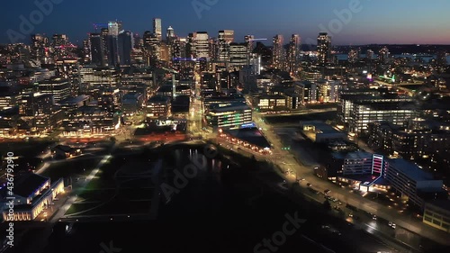 Cinematic 4K drone, after sunset, night dolly clip of downtown Seattle with illuminated streets and offices looking from South Lake Union in Seattle, Washington during blue hour