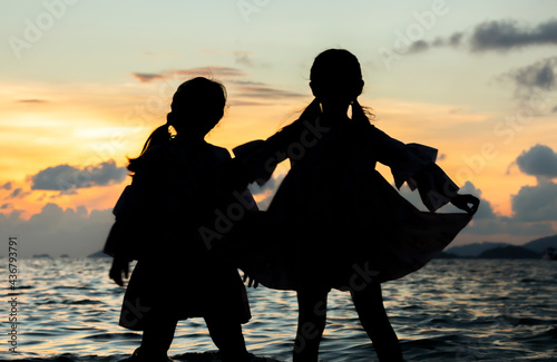sunset at the beach with the shadow of a girl